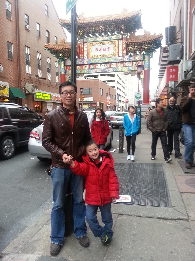 Daniel as a young child holding his dad’s hand on a city sidewalk