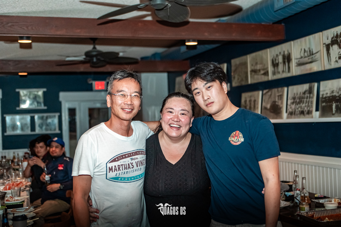 Daniel, now grown up, standing with his mom and dad at the restaurant