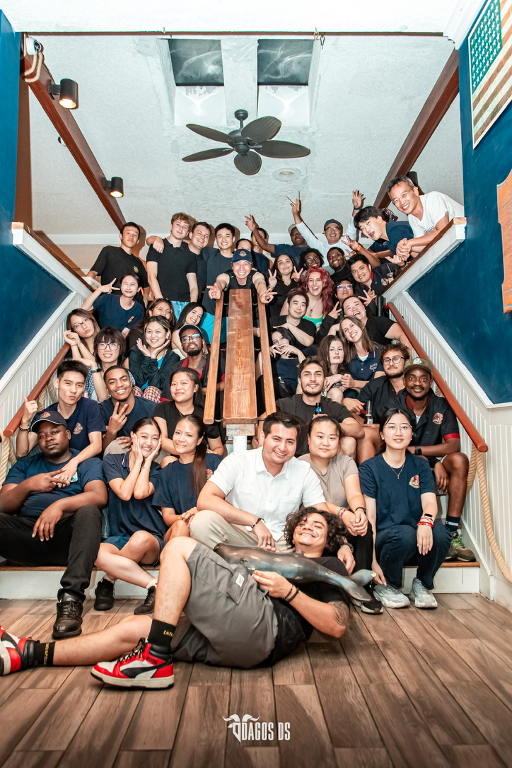 The OC Lobster Pot team gathered together on the restaurant staircase