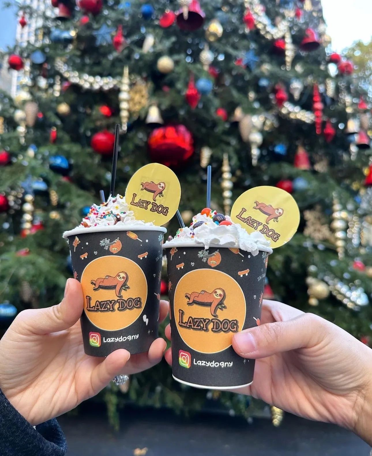 Two Lazy Dog drinks in front of a holiday tree in New York City