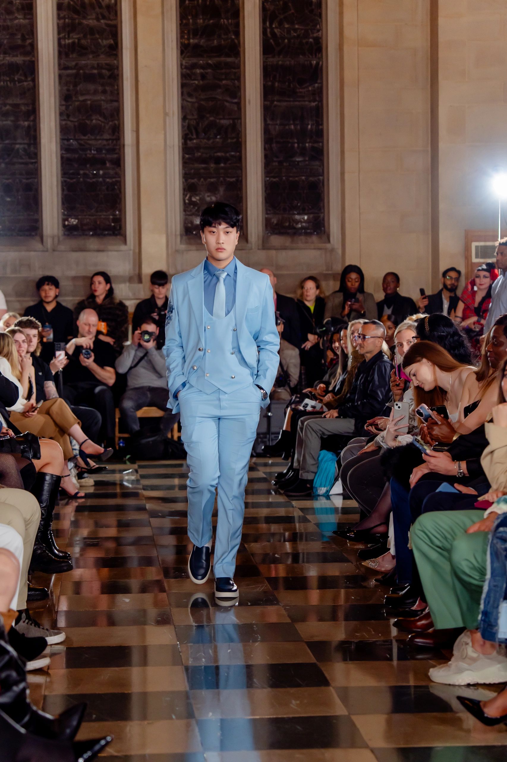 Daniel walking the London Fashion Week runway in a blue suit